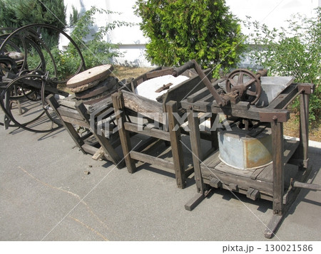 Vintage Grain Mill and Press Setup with Stone Wheels and Metal Container 130021586
