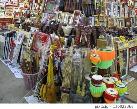 Market Stall Packed with Traditional Instruments, Framed Art, and Wooden Carvings Market Stall Packed with Traditional Instruments, Framed Art, and Wooden Carvings 130022369