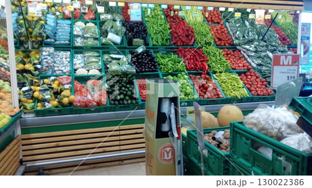 A Vibrant Vegetable Market Display with a Wide Variety of Fresh Produce in Green Crates 130022386