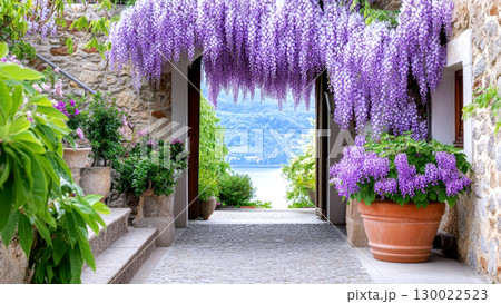 Enchanting wisteria tunnel in bloom stone pathway leading to serene lakeside view 130022523