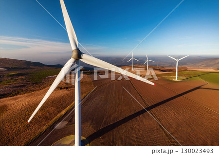 Close up View of Wind Turbine Blades Against a Blue Sky in a Rural Landscape Close up View of Wind Turbine Blades Against a Blue Sky in a Rural Landscape 130023493