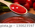 Spoon of ketchup or tomato sauce close-up 130023597