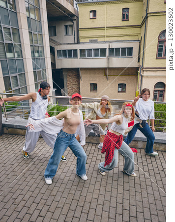 Street dancers showing unity and confidence with expressive urban movement outdoors 130023602