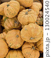A pile of orange pumpkins sits on the counter. A spoiled harvest. A moldy pumpkin. A pumpkin for festivals, Halloween and Thanksgiving. Farm stand 130024540
