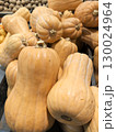 Pear shaped pumpkins, guitars lay on the counter in a pile. Orange pumpkins at the harvest festival. Pumpkin for Thanksgiving and Halloween. Ripe fresh vegetables, healthy food 130024964