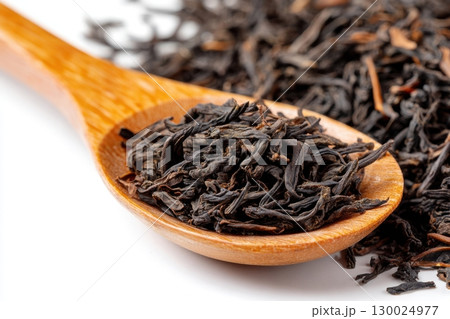 Dry black tea leaves in a wooden spoon isolated on white background. Pile of Dried fermented tea. Black Tea Leaves Heap. Close Up, Macro. Texture. Copy Space. Dried Tea. Abstract Food Drink Backdrop. Dry black tea leaves in a wooden spoon isolated on white background. Pile of Dried fermented tea. Black Tea Leaves Heap. Close Up, Macro. Texture. Copy Space. Dried Tea. Abstract Food Drink Backdrop. 130024977