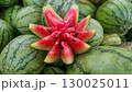 Close-up of freshly sliced watermelon with vibrant red flesh and seeds, paired with whole green striped melons on a wooden surface. Close-up of freshly sliced watermelon with vibrant red flesh and seeds, paired with whole green striped melons on a wooden surface. 130025011