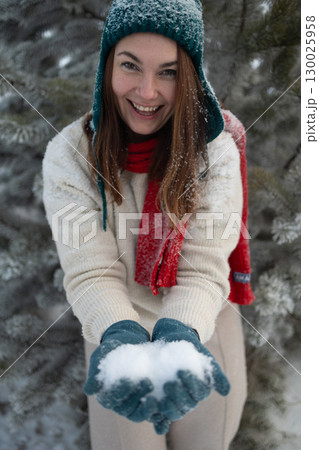 Laughing Woman Holding Snow on a Snowy Day in Winter Laughing Woman Holding Snow on a Snowy Day in Winter 130025958