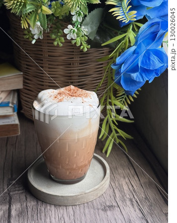 Delicious Cappuccino with Perfect Foam and Cocoa Dusting in a Minimalist White Cup 130026045