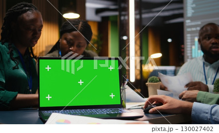 Diverse colleagues attending a late advisory board session with isolated pc, developing strategy and setting objectives for project agenda. Experts reviewing updates across the enterprise. Camera A. 130027402