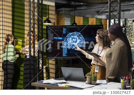 Powerful diverse team leveraging deep learning with big data algorithms, optimizing company performance with AI software and neural networks systems. Business solutions for growth. 130027427