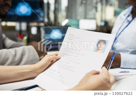 Close up of HR team using artificial intelligence systems to filter resumes, smart automation helping to evaluate applicants and streamline the onboarding process after interviews. Close up of HR team using artificial intelligence systems to filter resumes, smart automation helping to evaluate applicants and streamline the onboarding process after interviews. 130027622