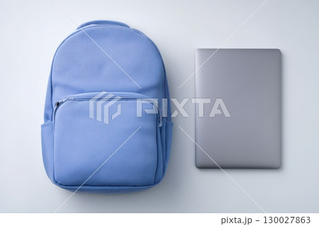 Blue laptop backpack on a white background. The bag is lying down. Bag with multiple pockets and zippers for storage, for carrying laptops or other small items. Office supplies 130027863