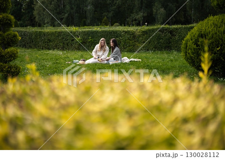 Enjoying a serene picnic amid lush greenery and vibrant foliage Enjoying a serene picnic amid lush greenery and vibrant foliage 130028112
