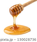 Golden honey pouring smoothly from a wooden dipper isolated on transparent background 130028736