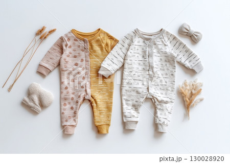 Baby onesie set on a light background. Fashion newborn clothes. Flat lay, top view. Baby kids soft clothing made from organic cotton. Infant trendy bodysuit natural colors, earth tones. Gender neutral 130028920