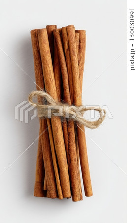 Top-Down View of Cinnamon Sticks Tied with Twine on White Background 130030991