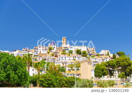Cityscape Altea old town with typical white houses traditional buildings in sunny summer day, Altea city historical centre Casco Antiguo, Alicante province, Valencian Community, Spain 130031140