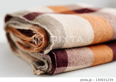 Cozy Folded Plaid Scarf in Fall Tones on White Background 130031239
