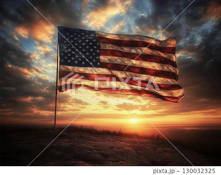 American flag waving proudly against a stunning sunset sky with dramatic clouds American flag waving proudly against a stunning sunset sky with dramatic clouds 130032325
