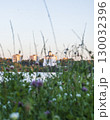 Sun is setting by the lake with city buildings and church on the background 130032396