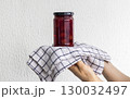 Woman holds on the towel home made jam 130032497