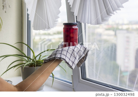 Woman holds on the towel home made jam Woman holds on the towel home made jam 130032498