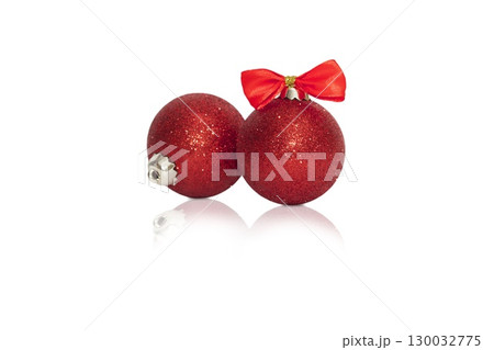 Composition of one red Christmas and New Year ball with red ribbon with reflection on white background 130032775