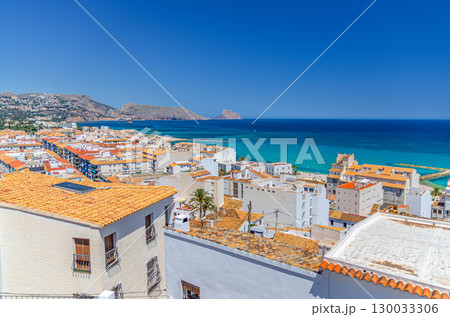 Altea old town aerial view with typical white houses buildings red tiled roofs, Altea bay Mediterranean Sea water, Morro de Toix and Ifac mountain in sunny day, Altea city historical centre, Spain Altea old town aerial view with typical white houses buildings red tiled roofs, Altea bay Mediterranean Sea water, Morro de Toix and Ifac mountain in sunny day, Altea city historical centre, Spain 130033306