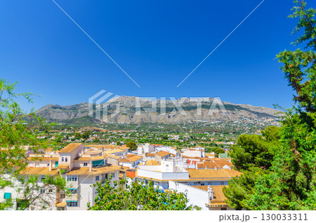 Altea old town aerial view with typical white houses traditional buildings red tiled roofs, Bernia mountain range in sunny day, Altea city historical centre Casco Antiguo, Alicante province, Spain 130033311