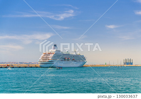 Grand cruise ship moored near pier in harbor Port of Alicante Puerto de Alicante, white cruise ship voyage in Mediterranean Sea water Alicante bay, concept travel on holiday, vacation summer, Spain Grand cruise ship moored near pier in harbor Port of Alicante Puerto de Alicante, white cruise ship voyage in Mediterranean Sea water Alicante bay, concept travel on holiday, vacation summer, Spain 130033637