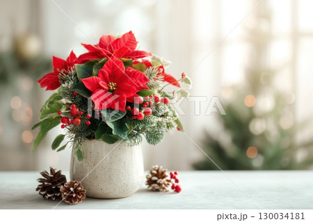 Poinsettia plant in a pot. Christmas Star flower. Festive red and golden holiday background with decorations and presents. The background is blurred. Traditional Xmas winter festive red flowers. 130034181