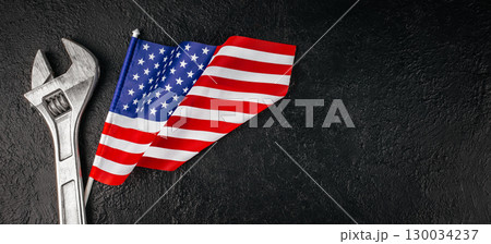 Concept of Labor Day in America with wrench and patriotic flag. Long banner format. top view. copy space 130034237