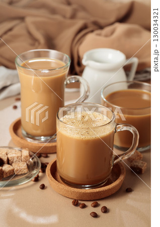 Latte with brown sugar on a beige background. Latte with brown sugar on a beige background. 130034321