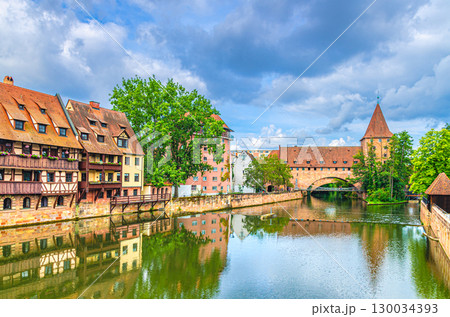 Schlayerturm Schlayer tower medieval building, Chained Suspension Bridge Kettensteg grouser, Pegnitzwehr and Pegnitz river in Old town Nuremberg city historic center, Middle Franconia region, Germany Schlayerturm Schlayer tower medieval building, Chained Suspension Bridge Kettensteg grouser, Pegnitzwehr and Pegnitz river in Old town Nuremberg city historic center, Middle Franconia region, Germany 130034393