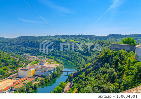 Aerial view of green Hills with forest along bank of Doubs river and Parc de la park near city in sunny summer day blue sky background, Bourgogne-Franche-Comte region, France 130034601