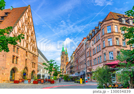 Old town Nuremberg city historical center, pedestrian street King Street with old medieval buildings, Mauthalle Former Customs House and Saint Lawrence church towers background, Germany Old town Nuremberg city historical center, pedestrian street King Street with old medieval buildings, Mauthalle Former Customs House and Saint Lawrence church towers background, Germany 130034839