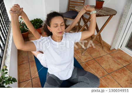 Mother and Child Practicing Yoga on a Relaxing Balcony 130034955