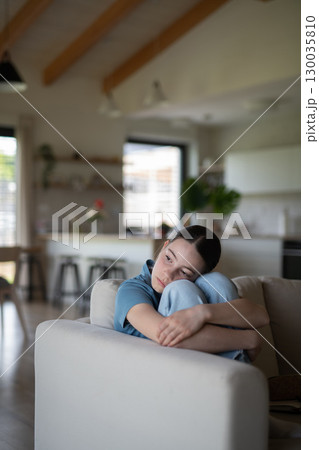 Teenage girl struggling with emotions in living room. Teenage girl struggling with emotions in living room. 130035810