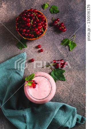 Red currant soy milk smoothie in glass on table top and vertical view Red currant soy milk smoothie in glass on table top and vertical view 130036176