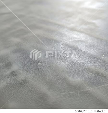 Shiny silver metallic fabric texture with smooth folds and soft highlights. 130036216