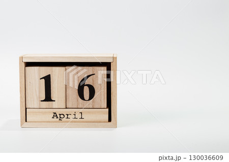 Wooden calendar April 16 on a white background Wooden calendar April 16 on a white background 130036609