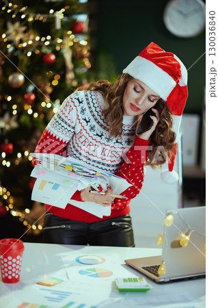 stylish business owner woman talking on phone and working 130036840