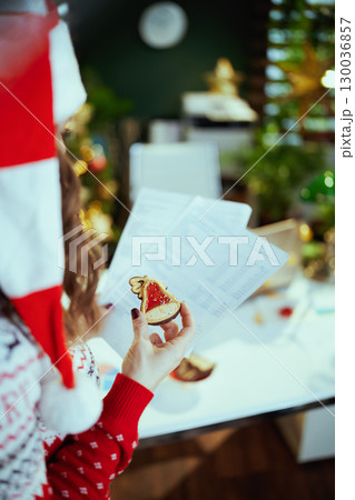 Business owner woman in green office with Christmas tree 130036857
