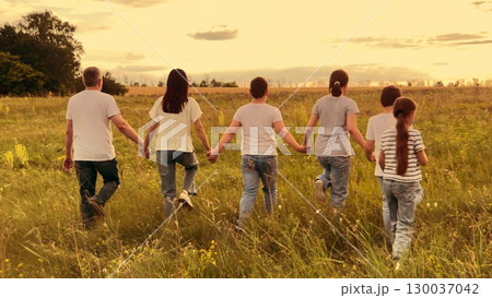 child parent, mother, father nature holding hand, happy family dream, Sunset horizon walk, Linking hands in love, Joyful family field, Rural wildflowers, Outdoor togetherness, Childhood and parenthood 130037042
