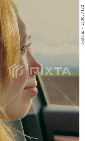 Contentment during a scenic drive, Girl's face shining with joy, Young woman s smile and freedom, Road journey and pure happiness, Living in the moment on the road, Smiling through new experiences 130037122