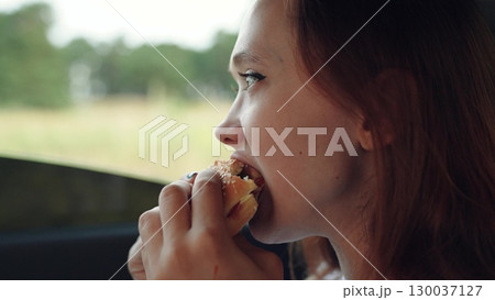 woman girl eating burger car, happy person, Girl eating a burger in the car, Young woman enjoys fast food, Eating lunch on the go, Tasty snack during a road trip, Close-up of girl with hamburger, Fast woman girl eating burger car, happy person, Girl eating a burger in the car, Young woman enjoys fast food, Eating lunch on the go, Tasty snack during a road trip, Close-up of girl with hamburger, Fast 130037127