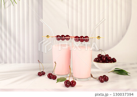 Cherry smoothie in glasses with fresh cream and fresh cherries on elegant table, detox diet and natural food concept, healthy breakfast with ingredients.healthy lifestyle advertisement, baby food. Cherry smoothie in glasses with fresh cream and fresh cherries on elegant table, detox diet and natural food concept, healthy breakfast with ingredients.healthy lifestyle advertisement, baby food. 130037394