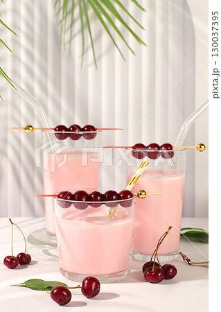 Cherry smoothie in glasses with fresh cream and fresh cherries on elegant table, detox diet and natural food concept, healthy breakfast with ingredients.healthy lifestyle advertisement, baby food. Cherry smoothie in glasses with fresh cream and fresh cherries on elegant table, detox diet and natural food concept, healthy breakfast with ingredients.healthy lifestyle advertisement, baby food. 130037395