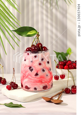 Cherry yogurt with berries in a glass on an elegant table, fruit salad, detox diet and natural nutrition concept, healthy breakfast with ingredients.advertisement of a healthy lifestyle, baby food. Cherry yogurt with berries in a glass on an elegant table, fruit salad, detox diet and natural nutrition concept, healthy breakfast with ingredients.advertisement of a healthy lifestyle, baby food. 130037404